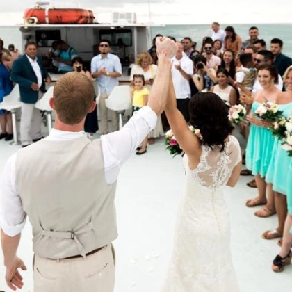 Bride and Groom holding hands on a boat