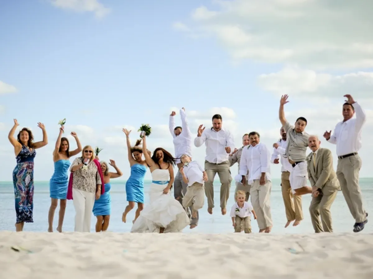 Wedding party jumping on the beach