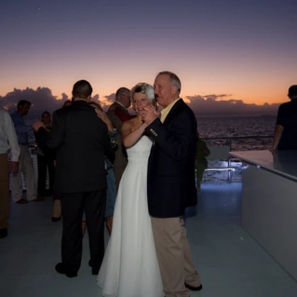 Bride and father of the bride dancing on a boat during a wedding