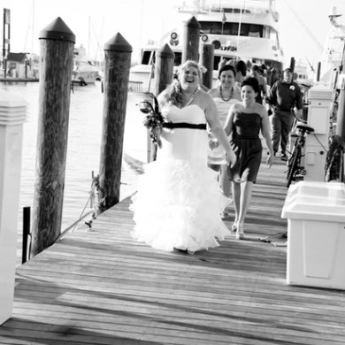 Bride walking with her bridesmaids down a boardwalk
