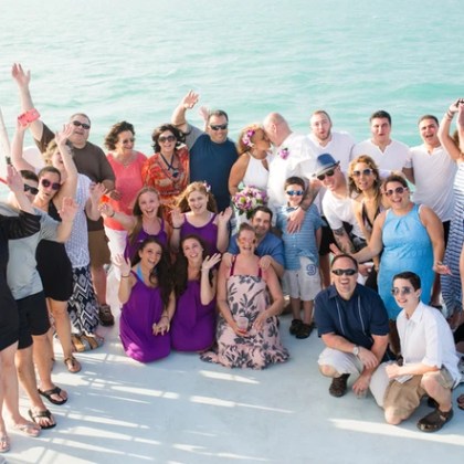 Wedding party posing for a photo on a sailboat