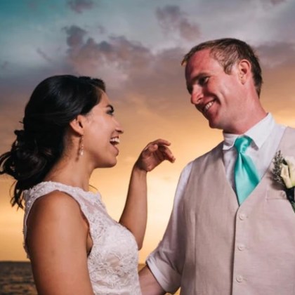 Bride and grooming smiling during a sunset