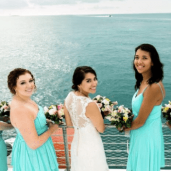 a group of people standing in front of a body of water