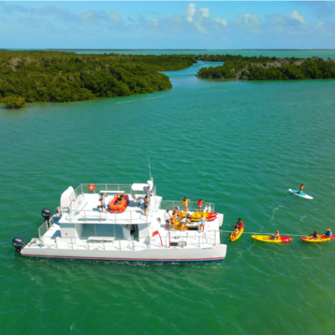 The Miss Valyn boat with people entering the water on kayaks